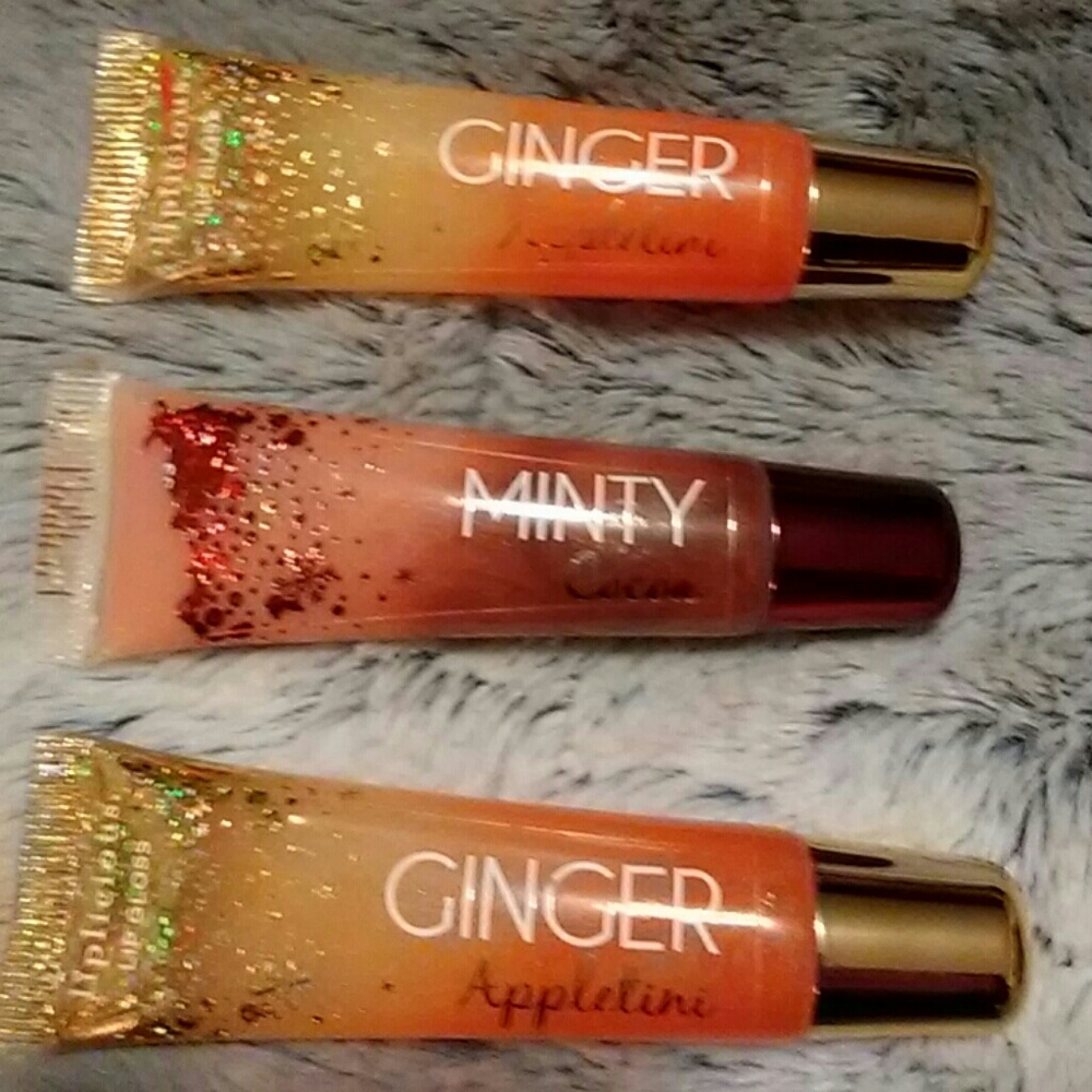 Three tubes of Liplicious lip gloss.